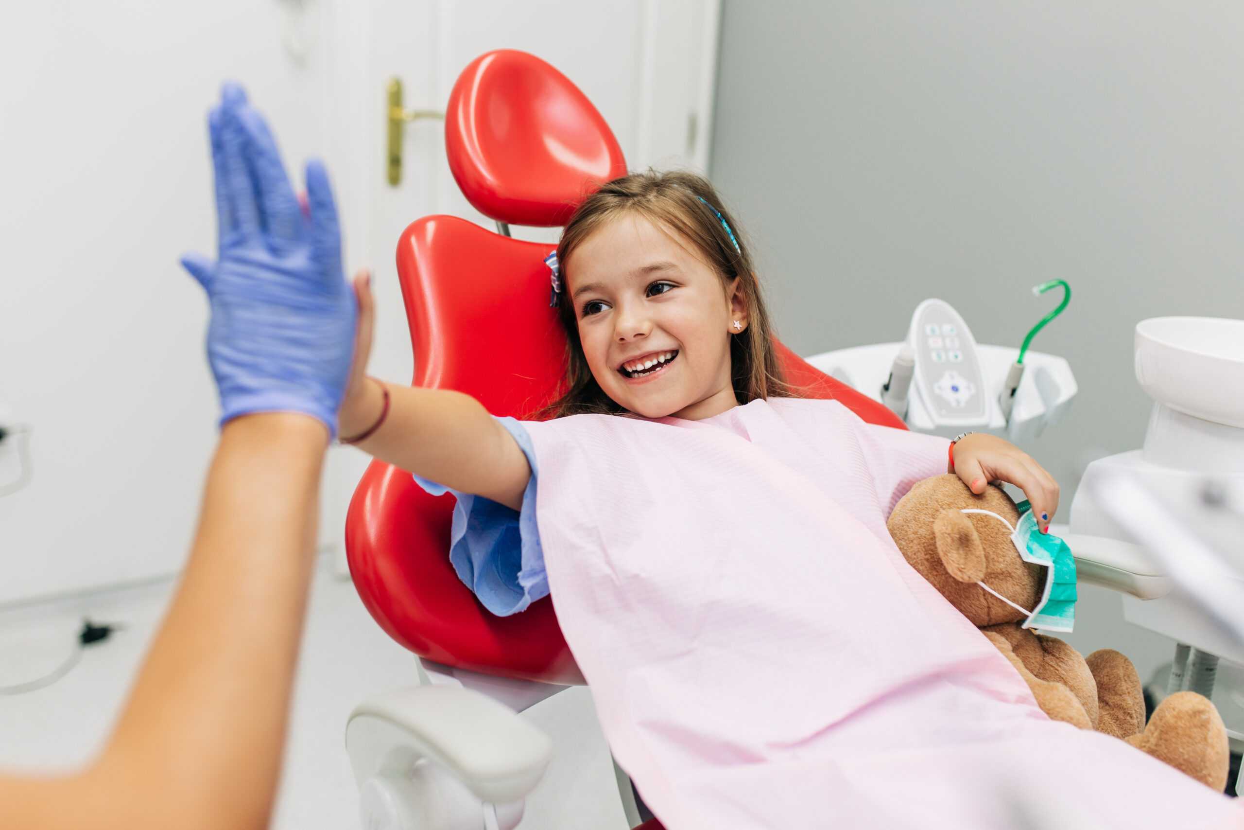 Kid on a dental bad with dentist