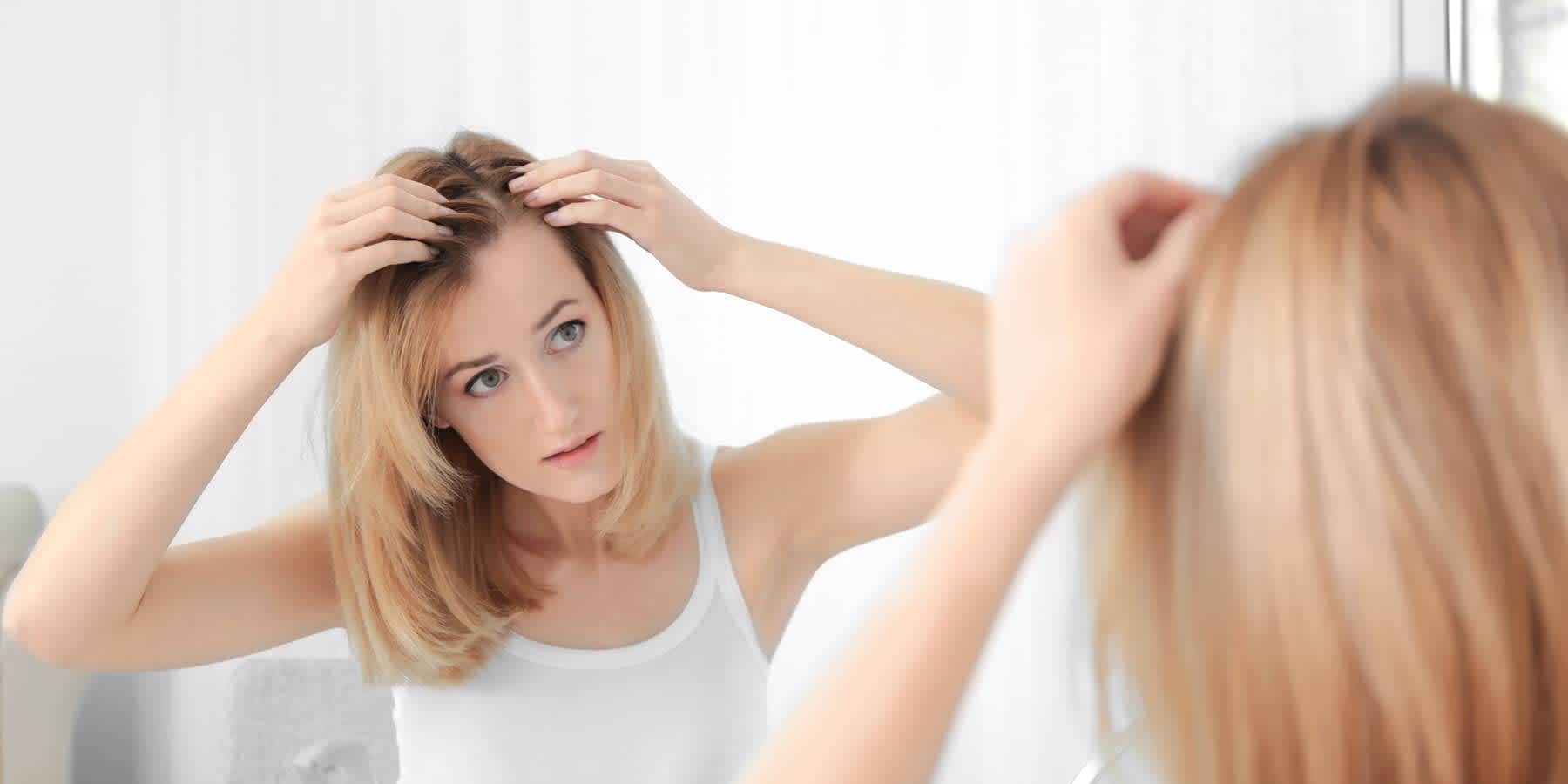 a girl watching herself in the mirror